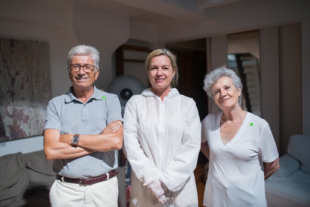 Group portrait of caregivers with senior adults in a home setting.